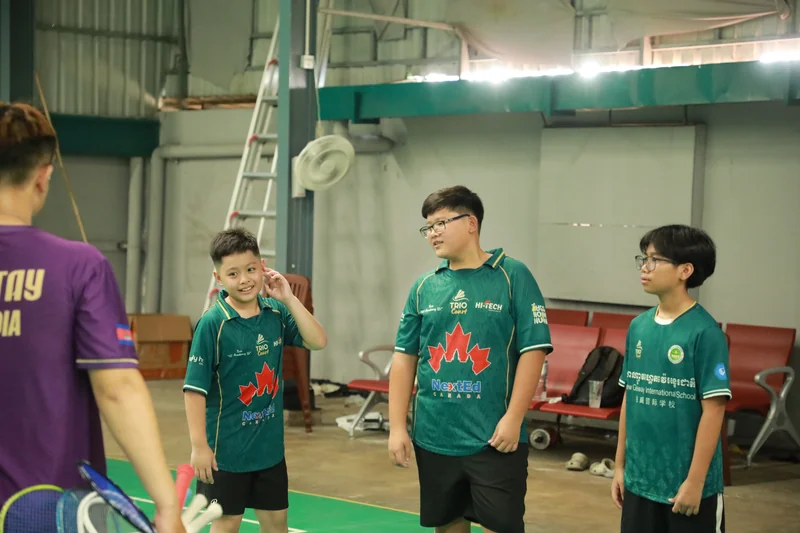 Trio Academy students in a group huddle